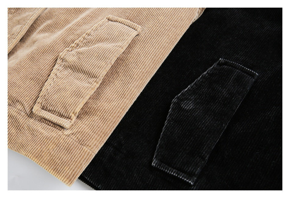 Close-up of tan and black corduroy jacket pockets and ribbed fabric.