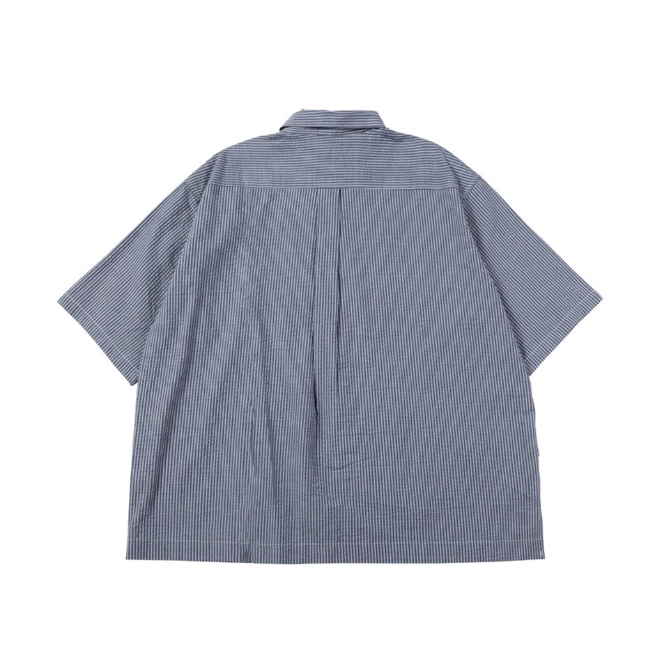 Back view of a blue-gray short-sleeve button-up shirt with fine stripes and a center pleat.