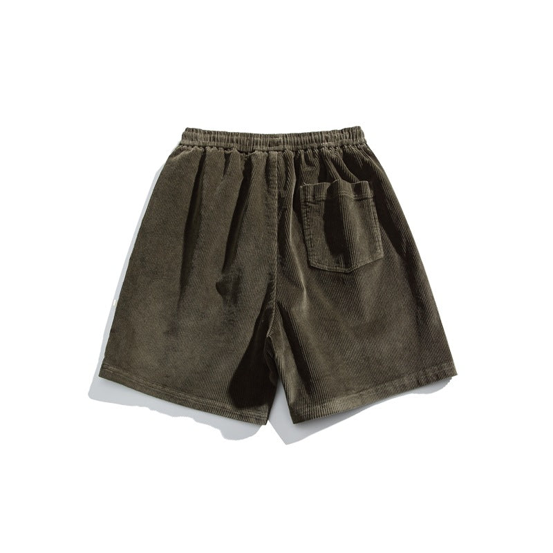 Olive-gray corduroy shorts shown from the back, with an elastic waistband and one patch pocket.