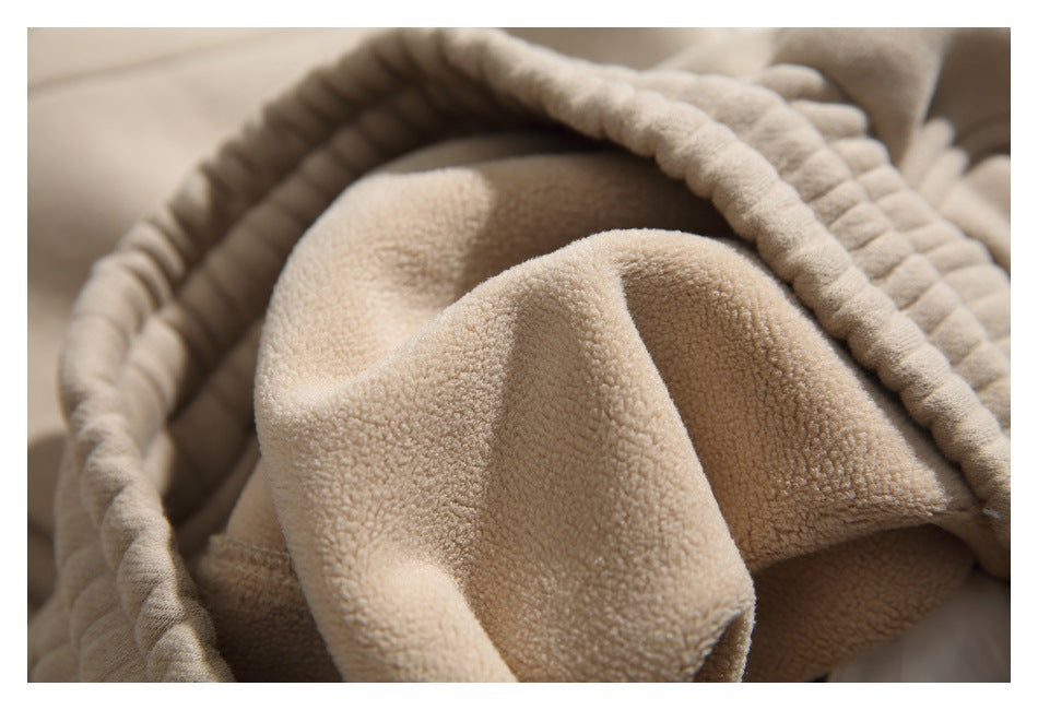 Close-up of the plush beige inner surface and elastic waistband of a garment.