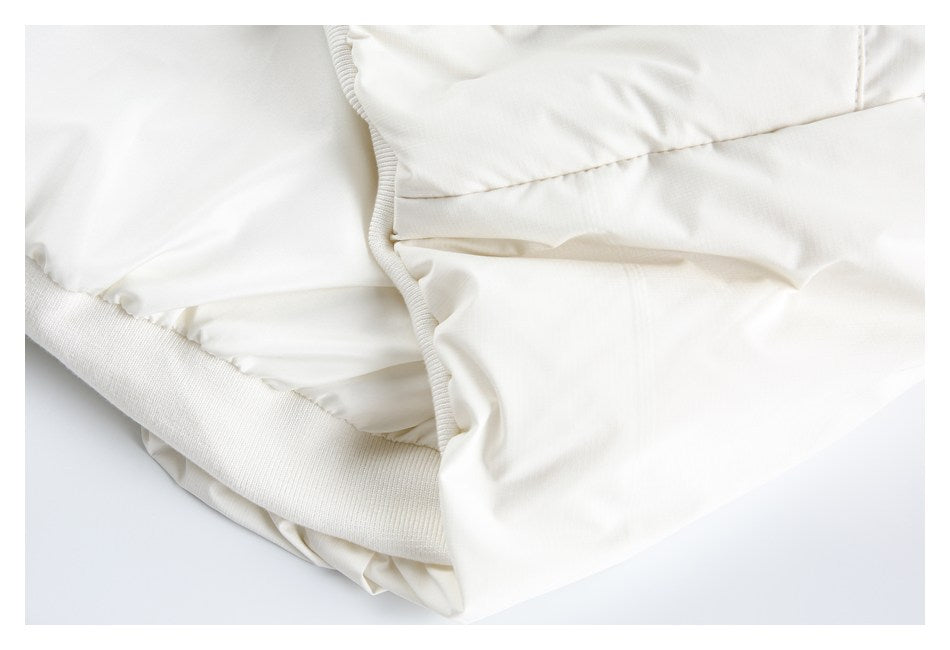 Close-up of a white garment's gathered lining and wide ribbed edge trim.