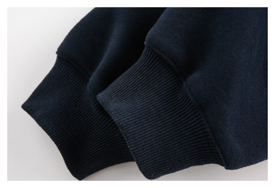 Close-up of two dark navy sweatshirt sleeve cuffs with ribbed knit trim.