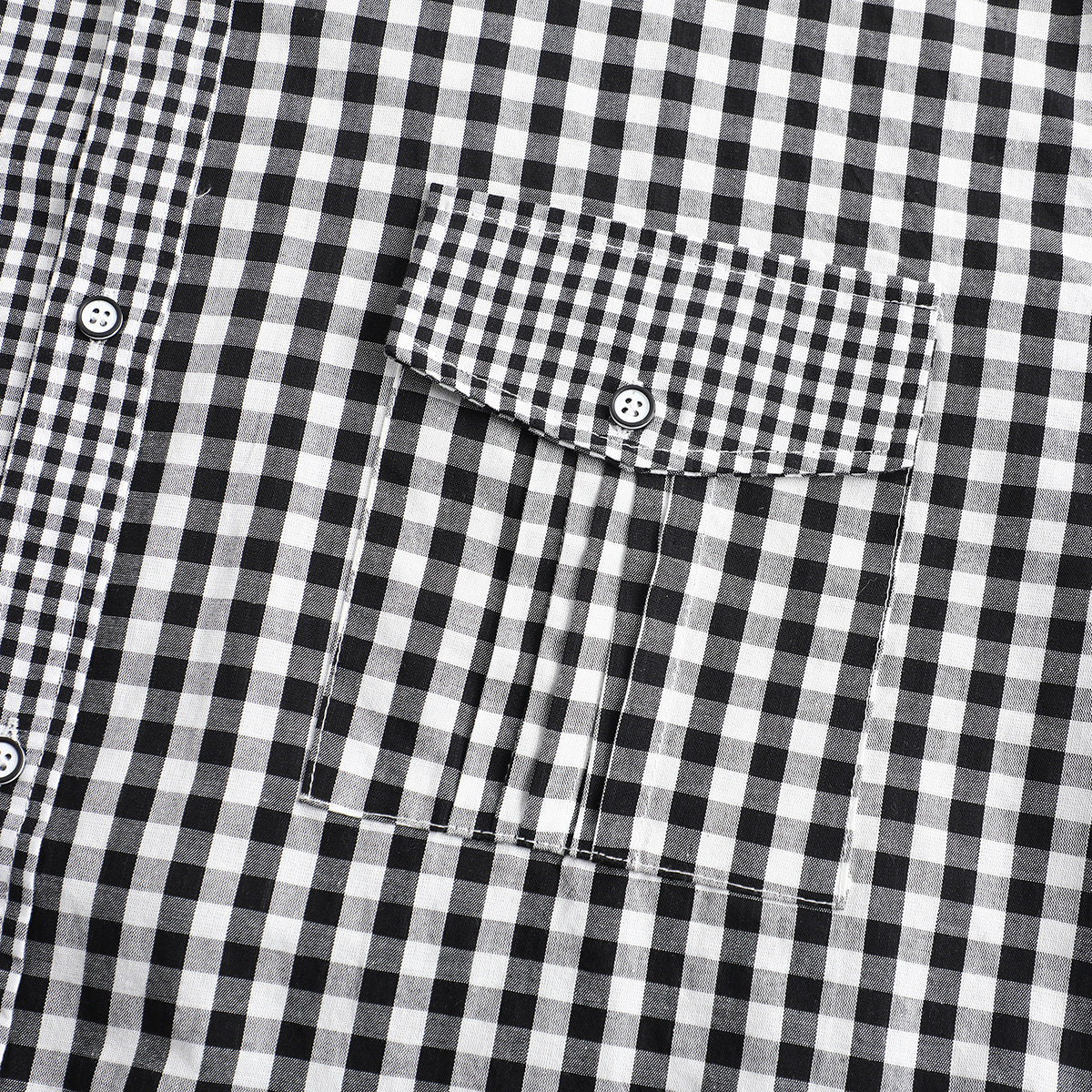 Close-up of a black-and-white check shirt pocket with a button flap and stitched pleats.