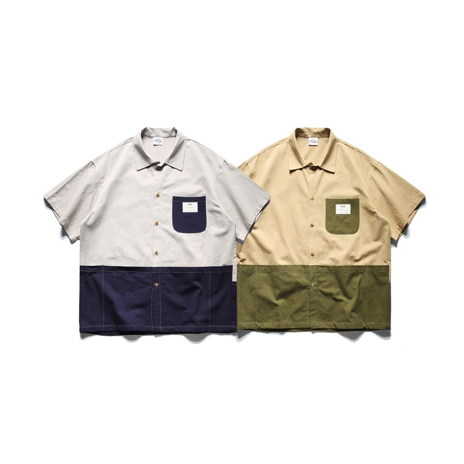 Two short-sleeve button-up shirts shown from the front: light gray with navy panels and tan with olive panels.