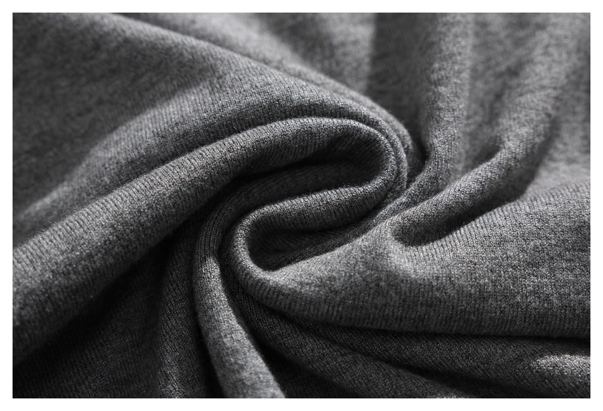 Macro view of gray knit fabric folded to show its texture and drape.