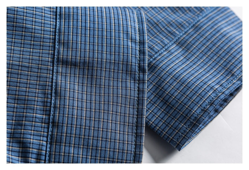 Close-up of blue plaid shirt fabric with a folded sleeve edge.