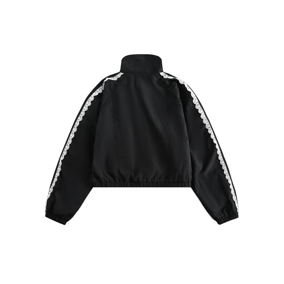 Back view of black cropped jacket with stand collar, white lace-trimmed sleeve stripes, and elastic hem and cuffs