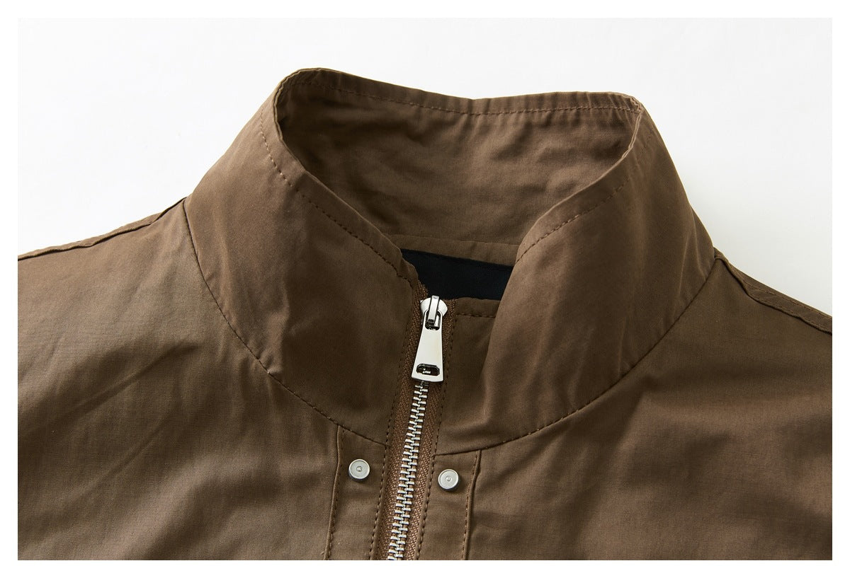 Close-up of a brown jacket's stand collar, silver front zipper, and snap-button placket.