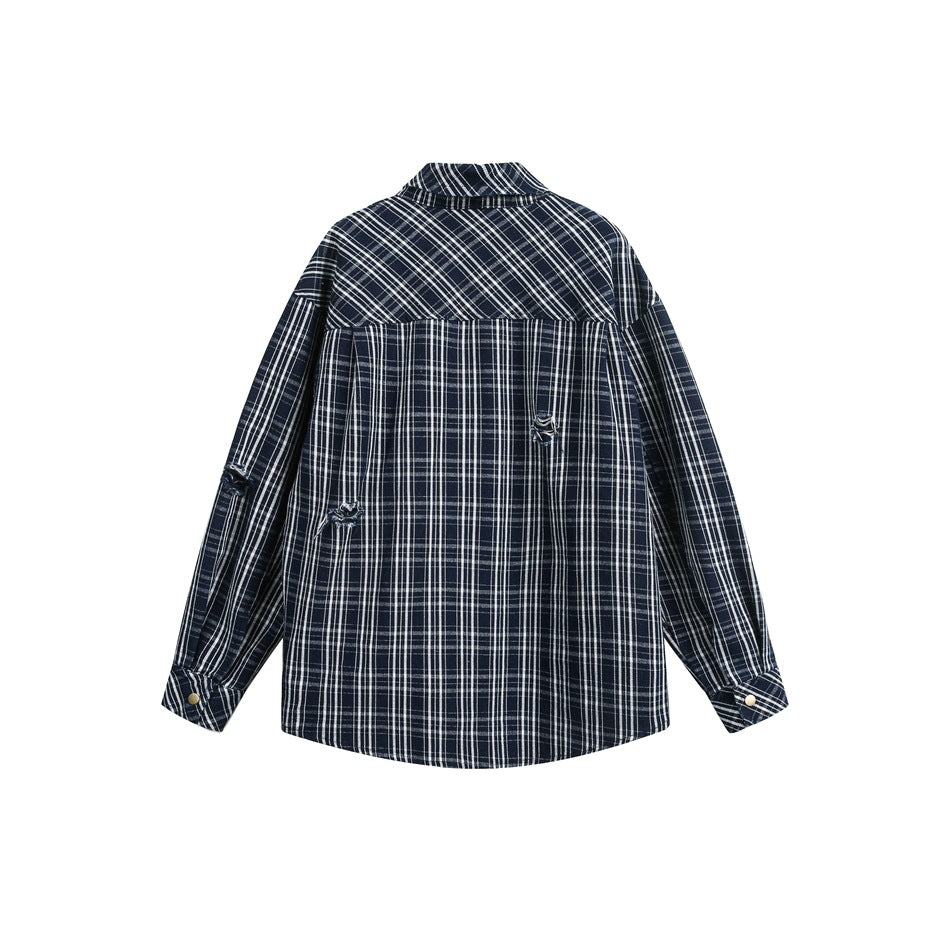 Back of a navy-and-white plaid shirt laid flat, showing a yoke, long sleeves, and buttoned cuffs.