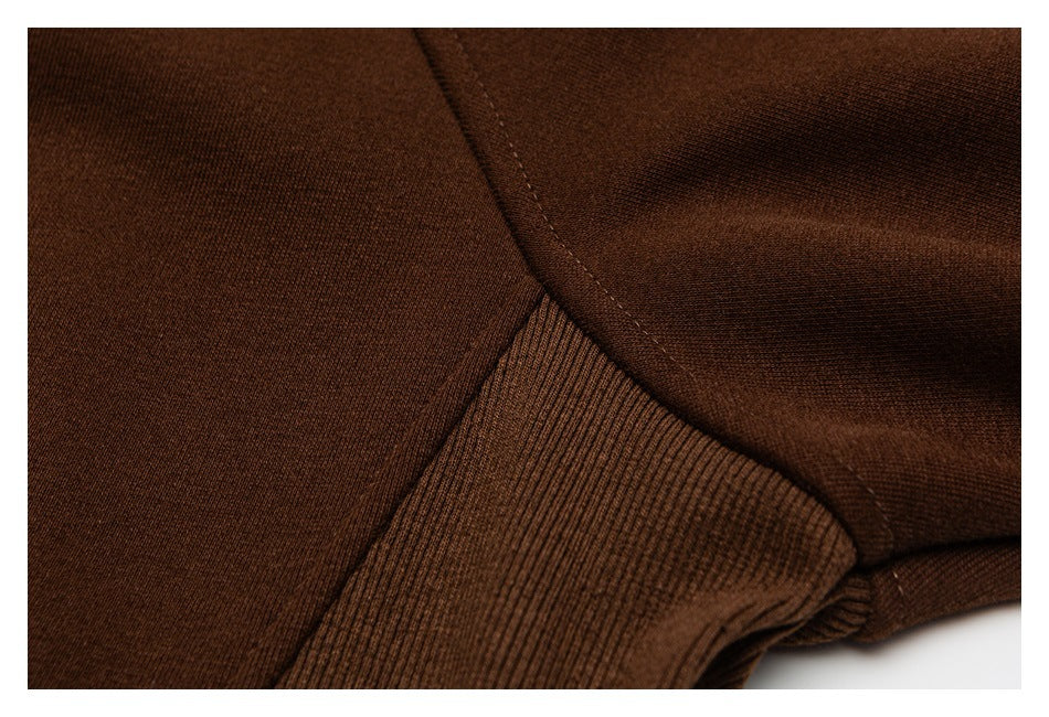 Close-up of a ribbed brown cuff and stitched garment seam.