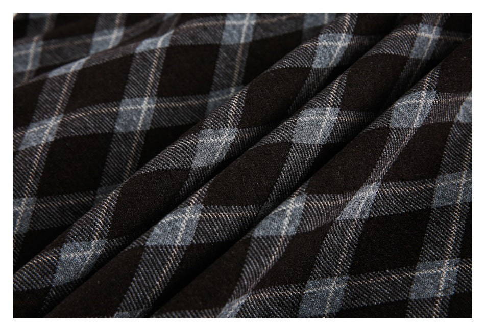 Close-up of dark gray plaid fabric arranged in soft folds.