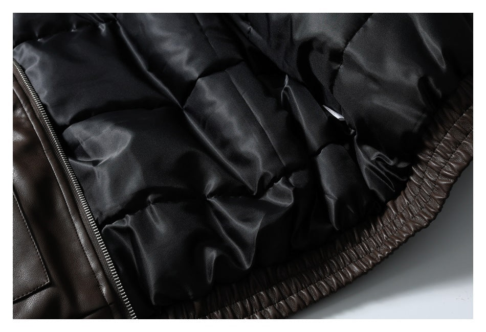 Inside view of the jacket's black quilted lining, zipper edge and gathered dark brown hem.