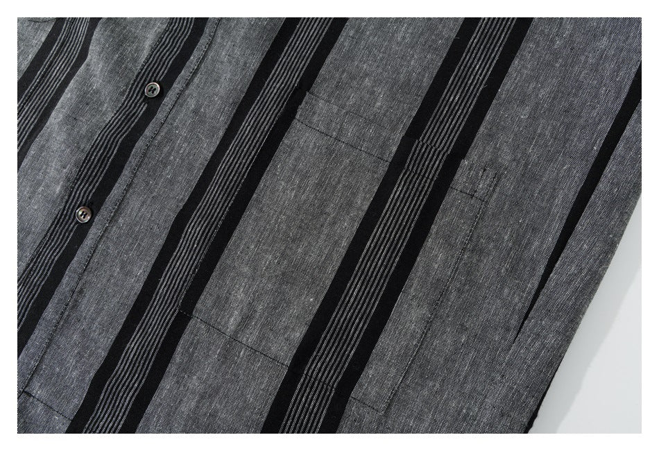Close-up of the black and gray striped shirt front with buttons and a chest pocket.