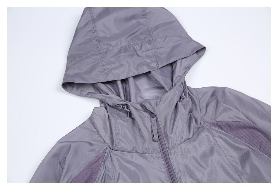 Close-up of a lavender-gray jacket hood with drawcords, a high collar and the top of its front zipper.