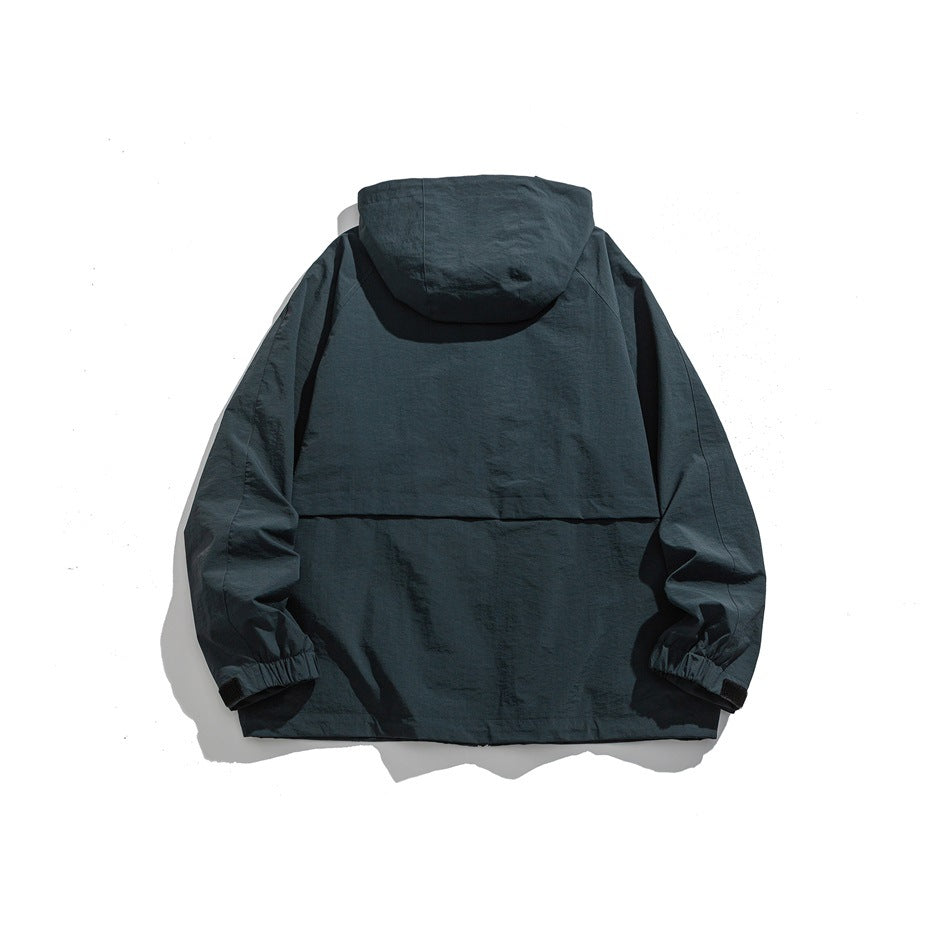 Back view of a dark blue hooded jacket with elastic cuffs and a horizontal back flap.