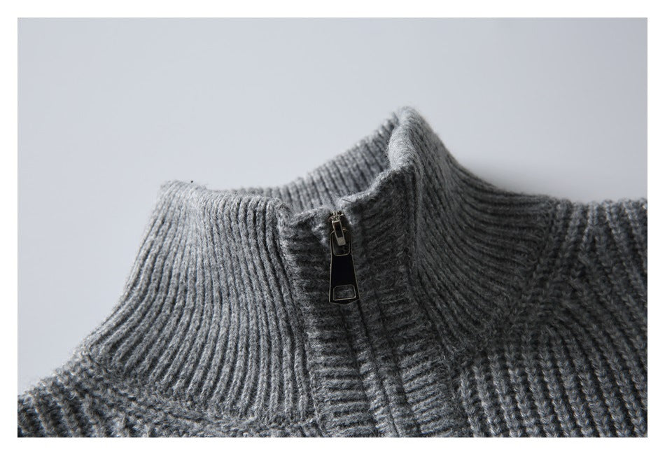 Close-up of a gray rib-knit sweater's tall collar and short zipper.