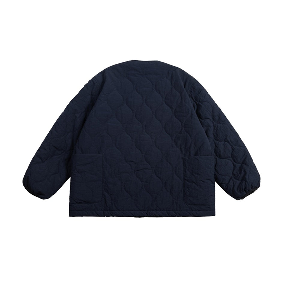 Back view of a dark navy quilted jacket with long sleeves and two large lower patch pockets.