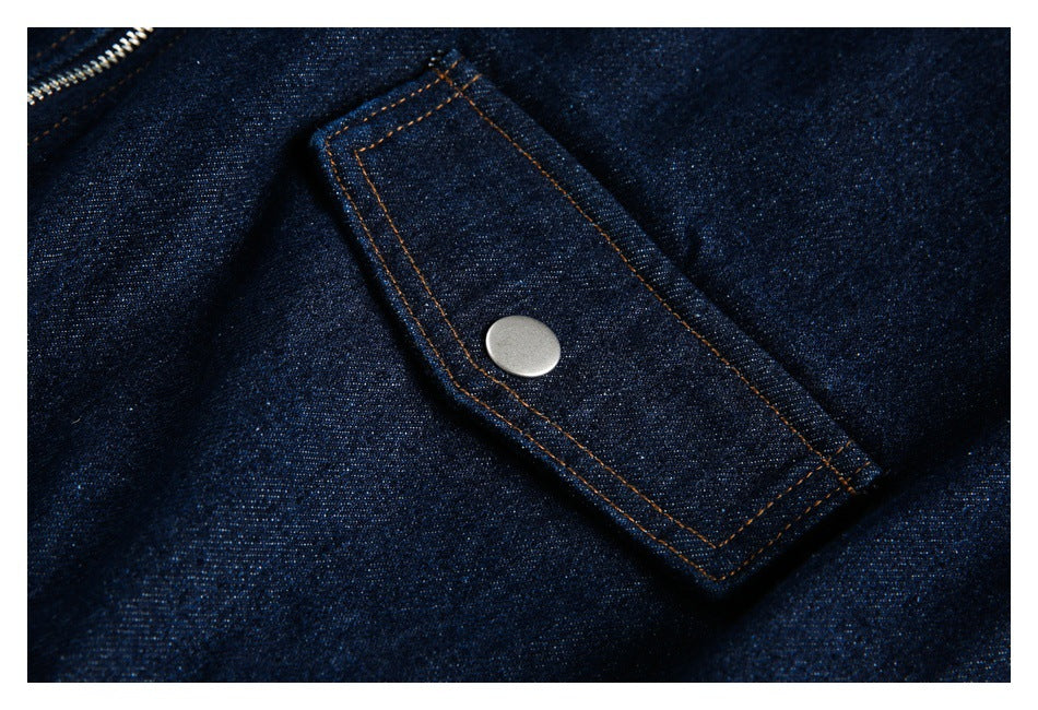 Close-up of a rectangular denim tab with a silver snap and contrast stitching.
