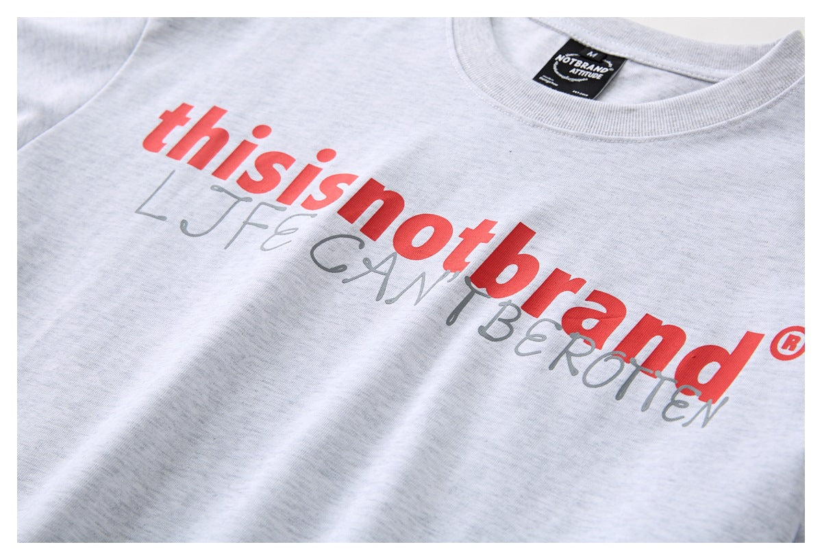 Close-up of a light gray T-shirt neckline and chest with red and gray printed lettering.