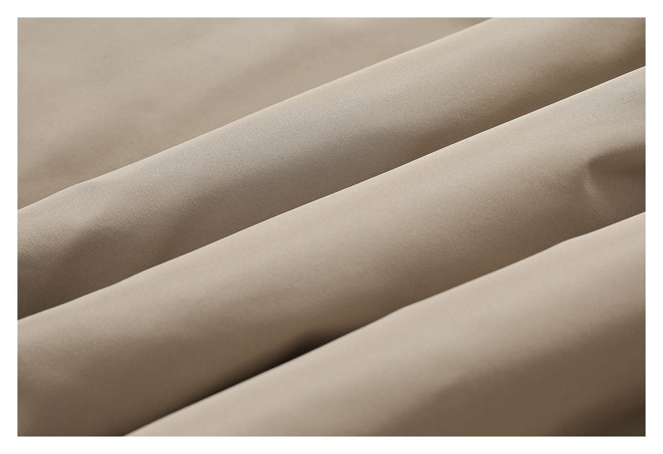 Macro view of smooth beige fabric arranged in soft folds.