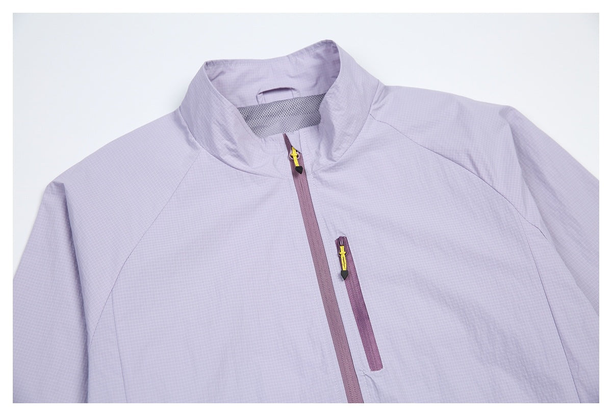 Close view of the pale lavender jacket front, showing its stand collar, main zipper, and vertical zip pocket.