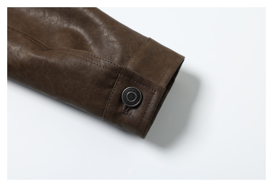 Close-up of a brown sleeve cuff with a dark snap button and visible stitching.