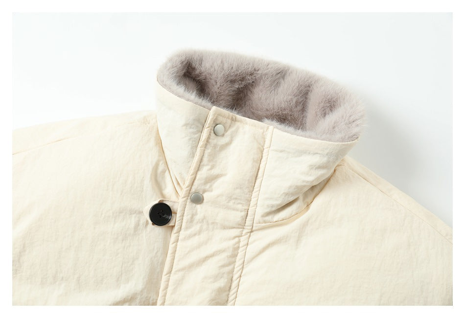 Close-up of the ivory jacket's tall collar, gray faux-fur lining, and snap and button fastening.