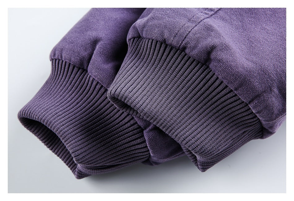 Close-up of the purple jacket's wide ribbed cuffs and sleeve seams.