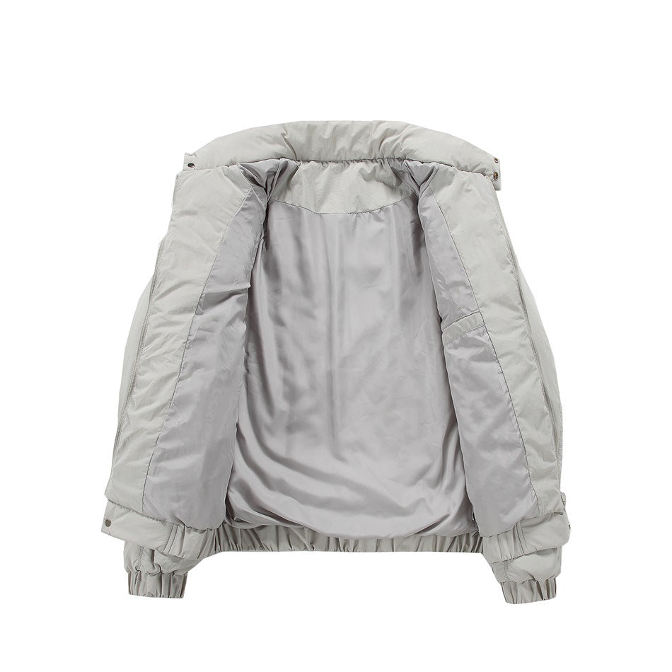 Light gray jacket opened flat to show its smooth lining, collar, and elasticated hem and cuffs.