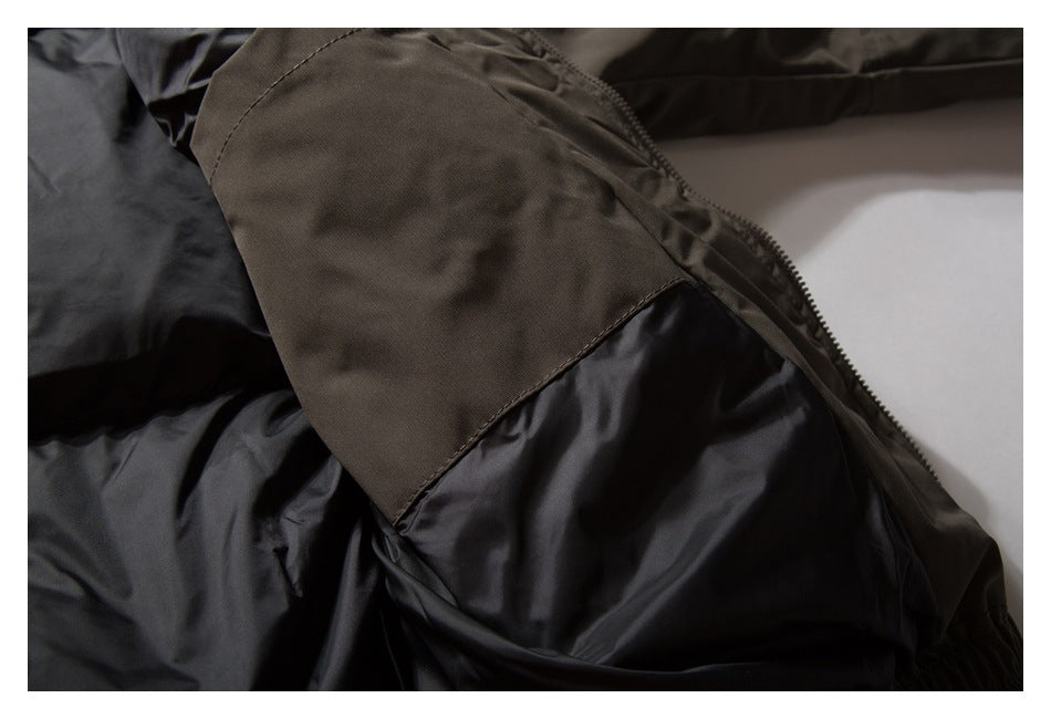Close-up of a dark brown garment panel beside black lining, with a seam and zipper visible.