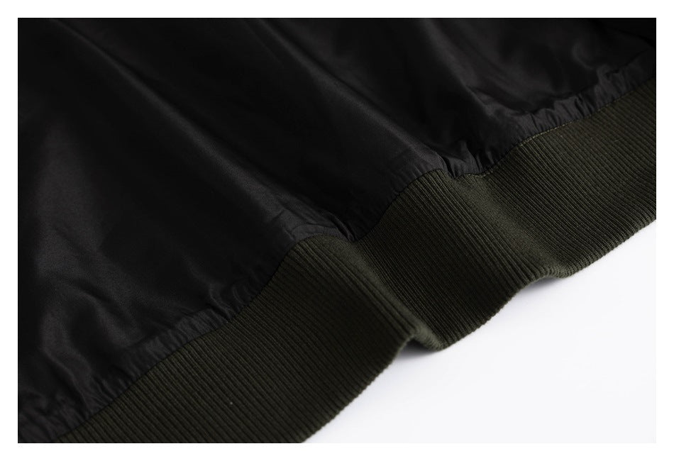 Close-up of the jacket's black lining and dark olive ribbed hem.