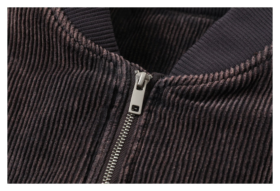 Close-up of the jacket's metal zipper and ribbed fabric at the collar.