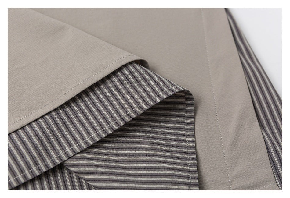 Close-up of a taupe garment showing stitching and a gray striped inner facing.