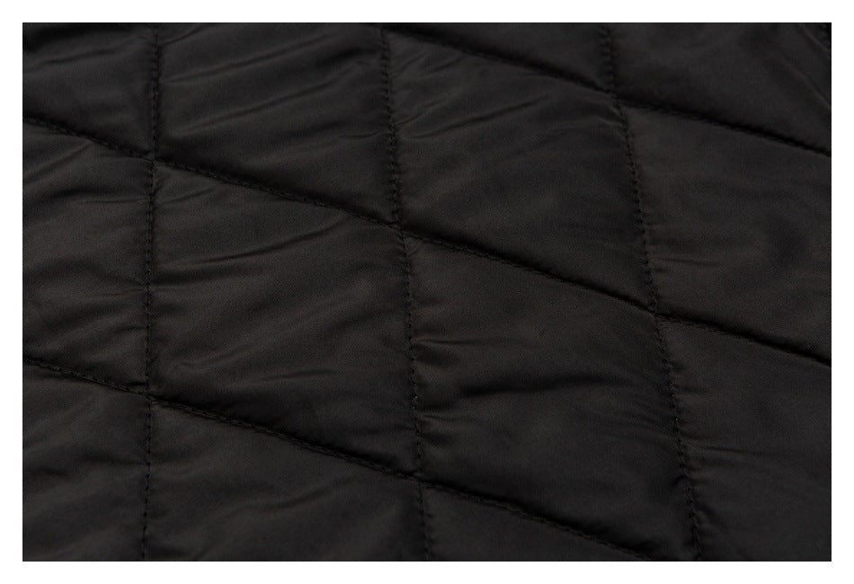 Close-up of black quilted lining with geometric stitched seams.