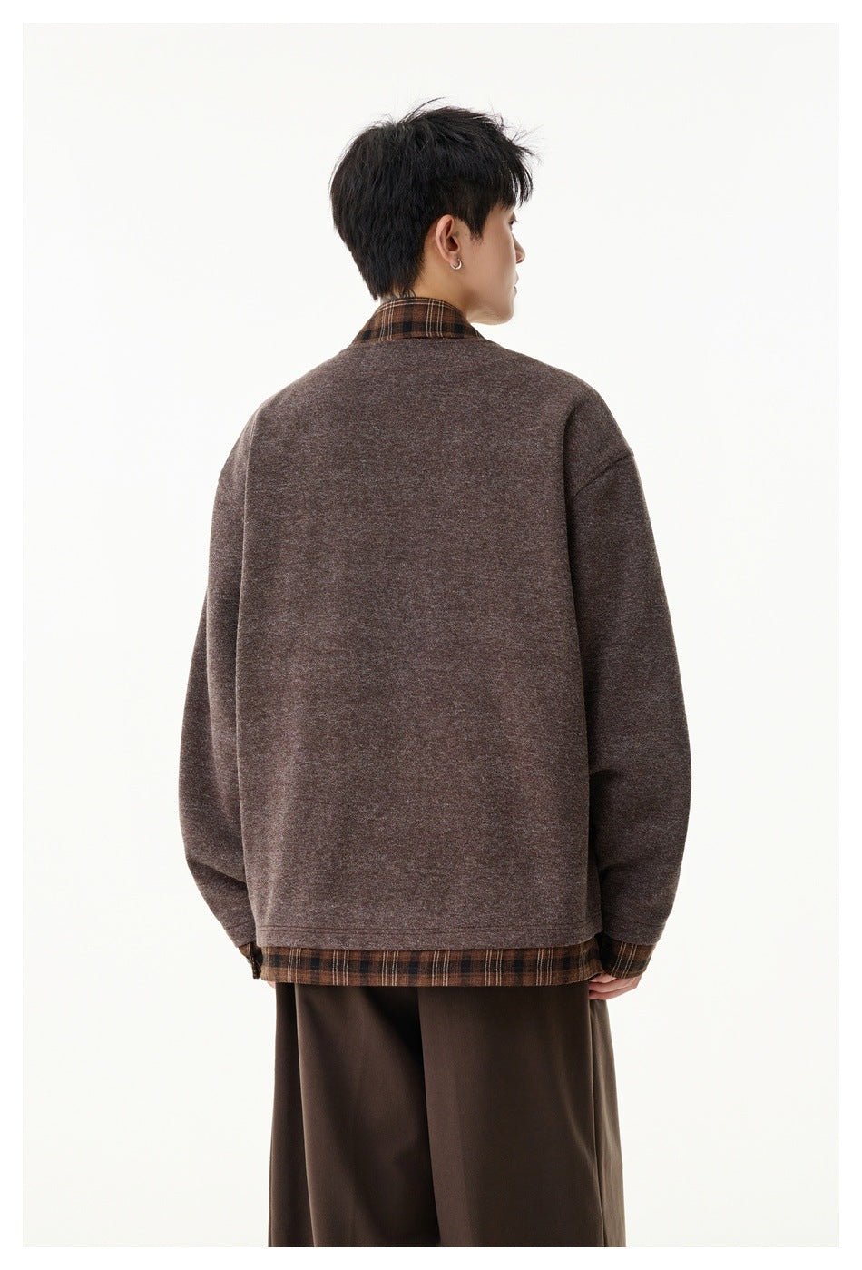Back view of a model wearing a muted brown jacket, with brown plaid shirt collar and hem visible.