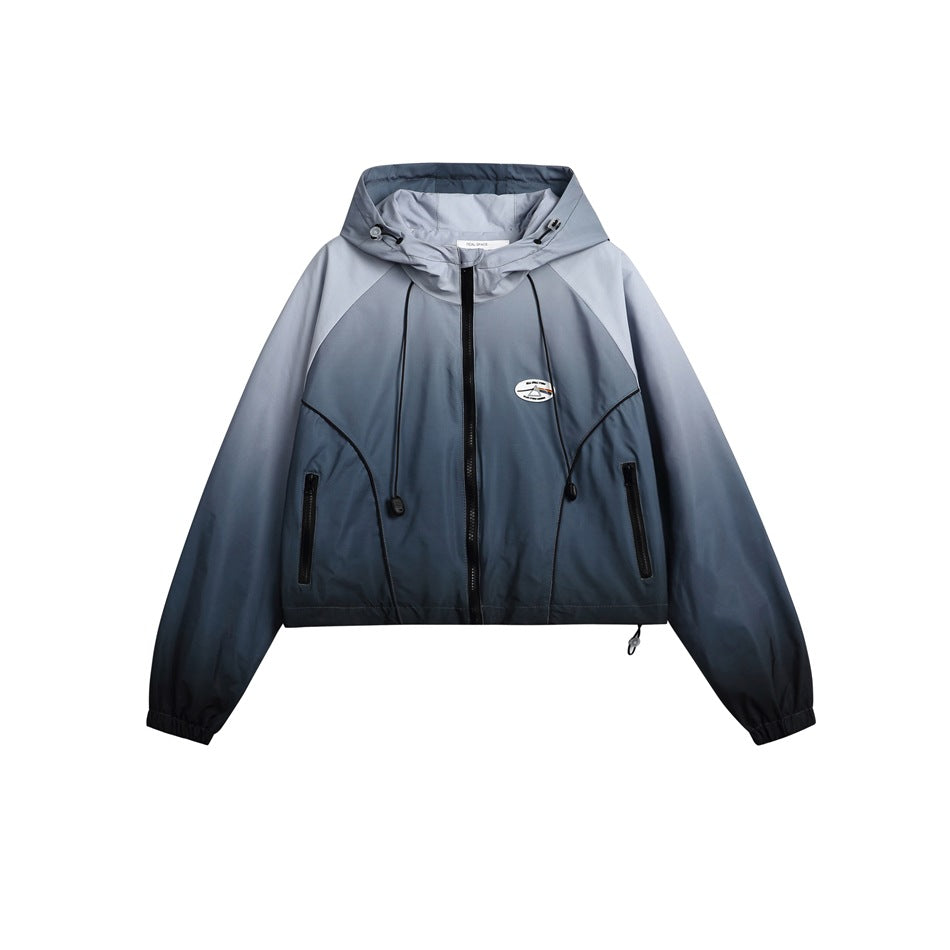 Front view of a cropped blue-gray gradient hooded jacket with a zip front and two zip pockets.