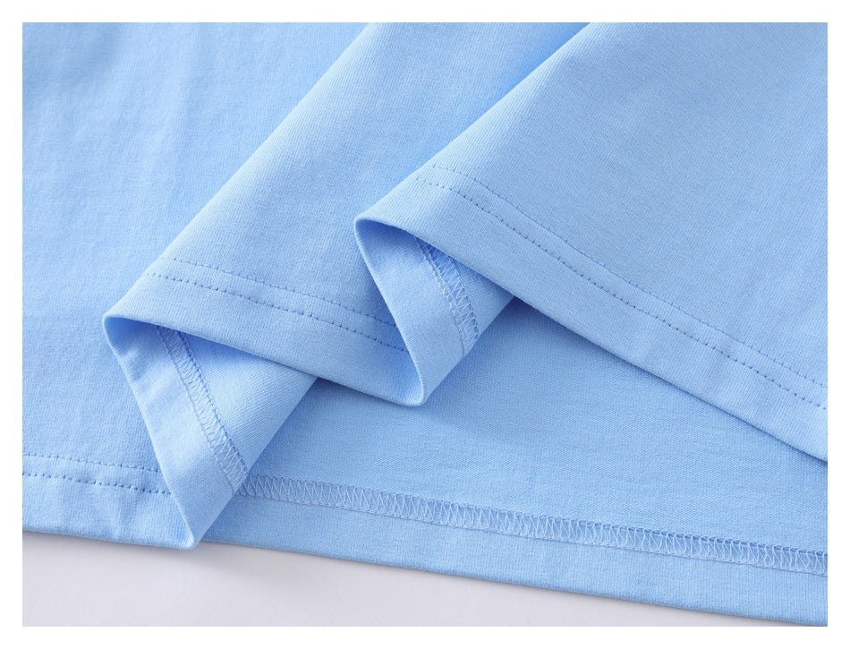 Close-up of a light blue shirt hem showing folded edges and double-needle and overlock stitching.