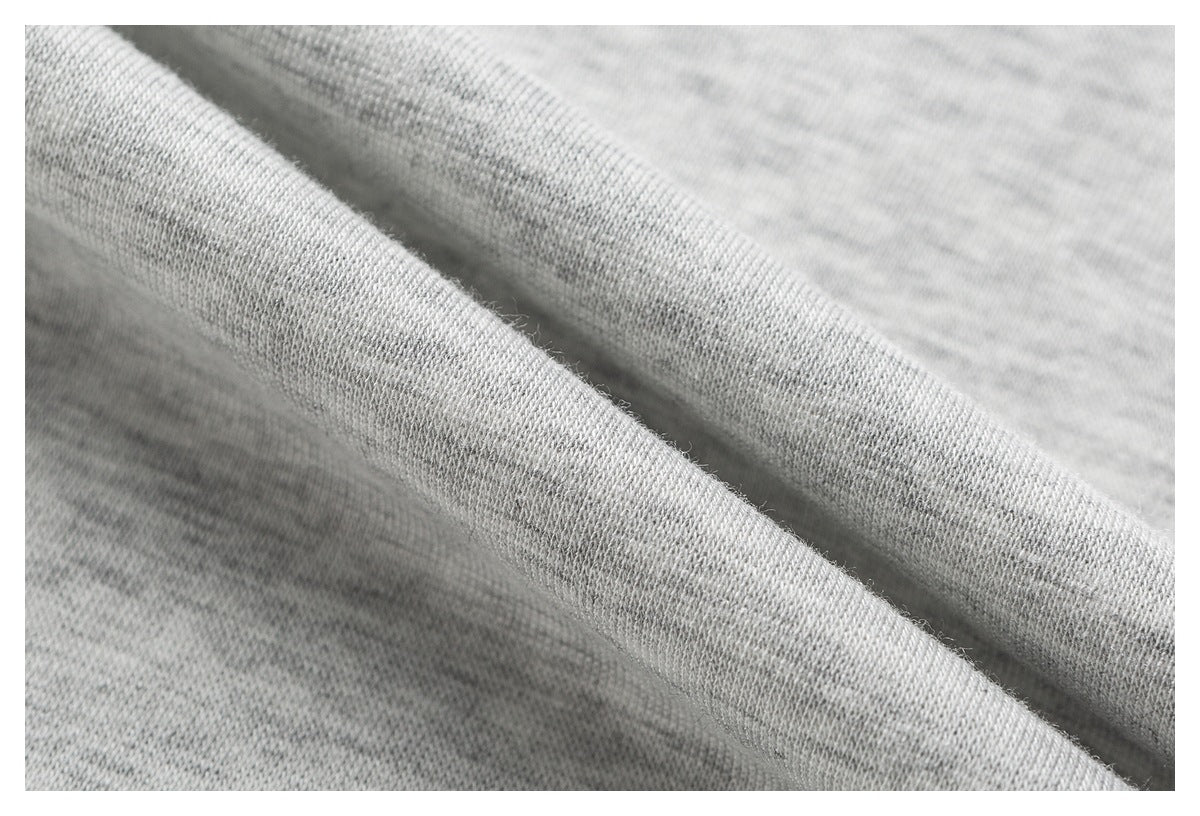 Close-up showing the soft-looking knit texture and folded edge of light gray heathered fabric.
