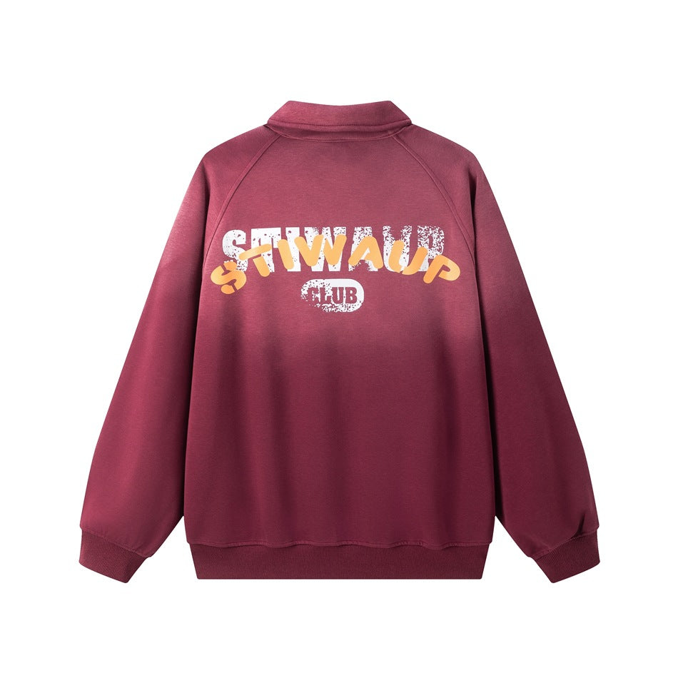 Back of a burgundy long-sleeve collared pullover, shown flat with large white and yellow lettering.