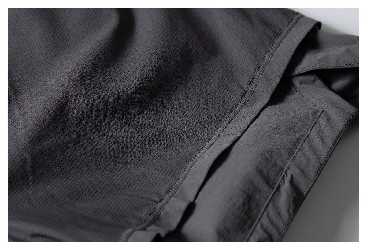 Close-up of dark charcoal perforated fabric beside a stitched edge and smooth fabric panel.