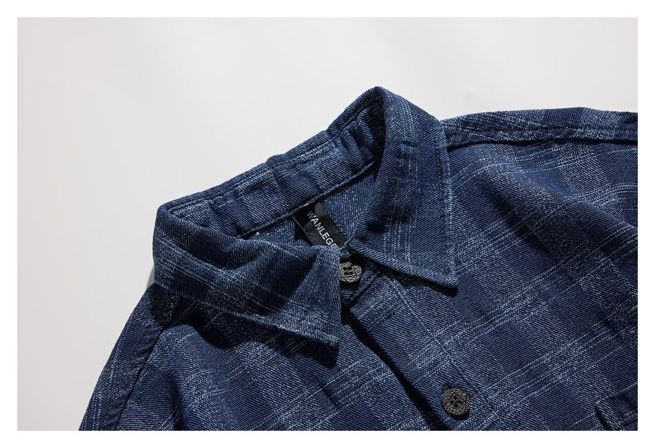 Close-up of a dark blue plaid shirt collar, neckline label and buttons.