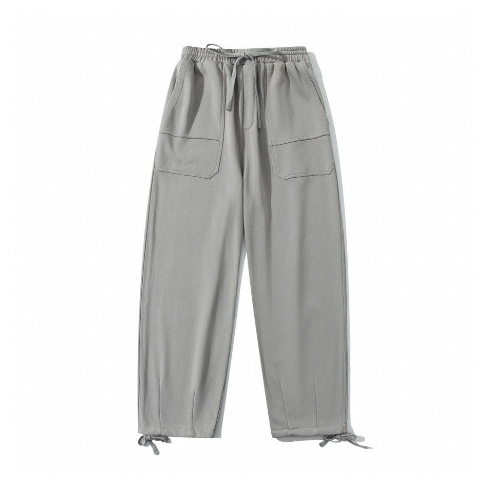 Gray drawstring sweatpants, front flat lay, with large front pockets and ankle tie cords