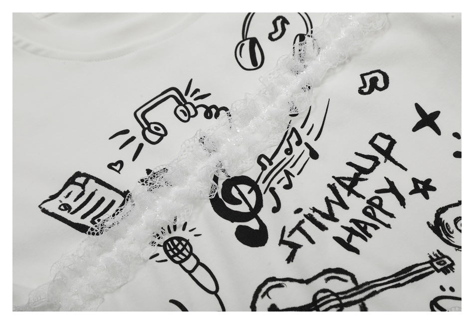 Closer view of the T-shirt's black music doodles and lettering beneath diagonal white lace trim.