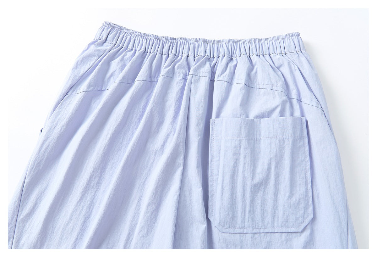 Back view of pale lavender pants with an elastic waistband and a large patch pocket.