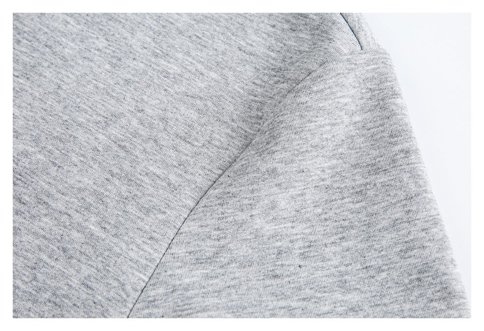 Close-up of gray fabric and a curved seam on a top.