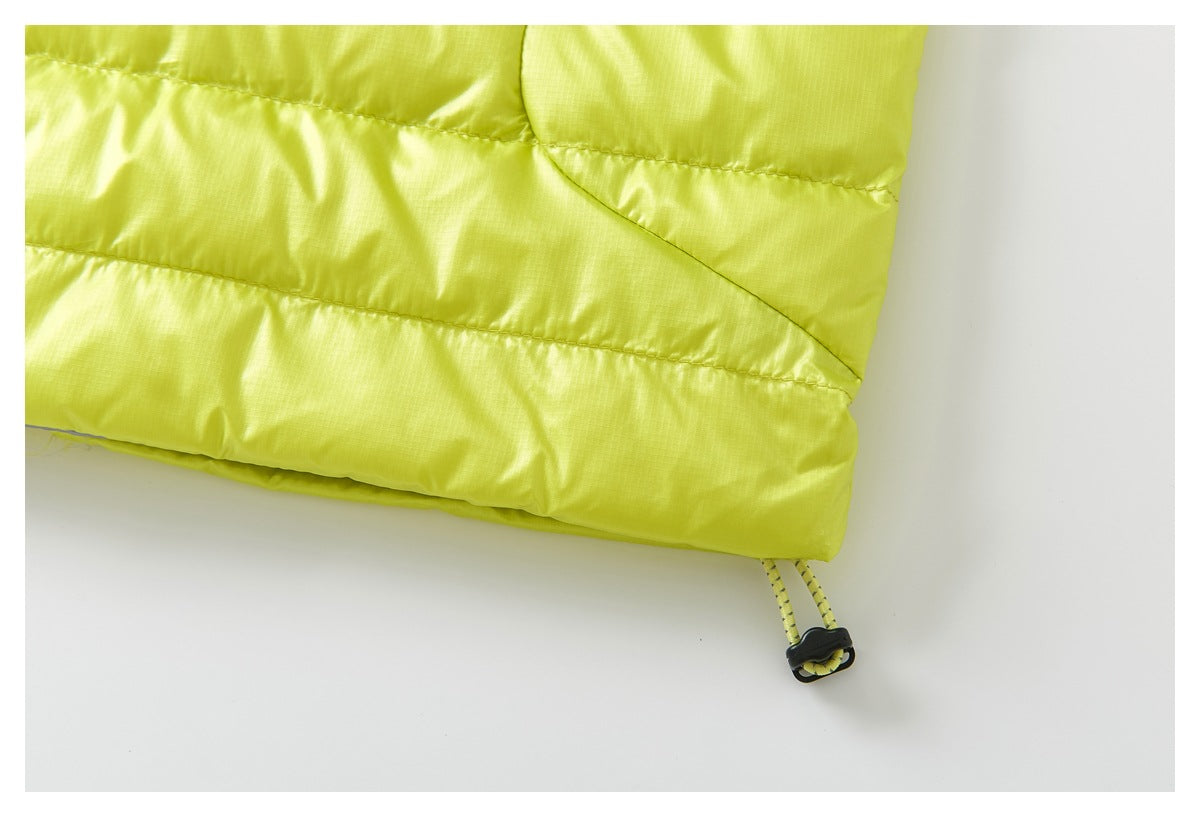 Close-up of the chartreuse vest hem with quilted panels and an adjustable drawcord toggle.