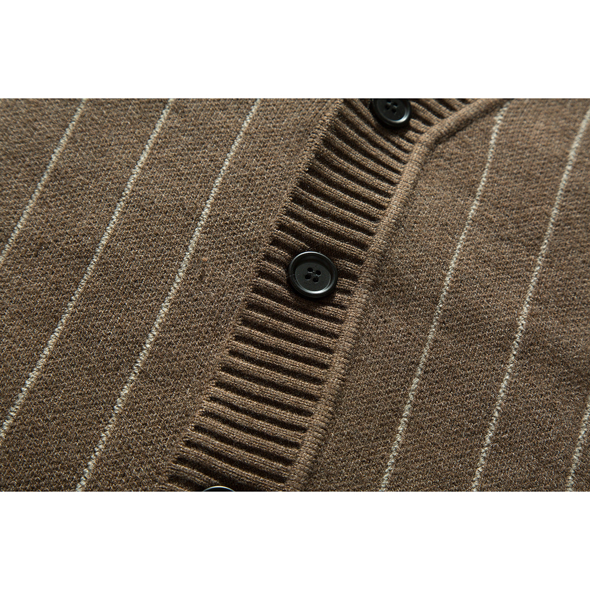 Close-up of a brown cardigan's vertical stripes, ribbed button placket, and dark buttons.