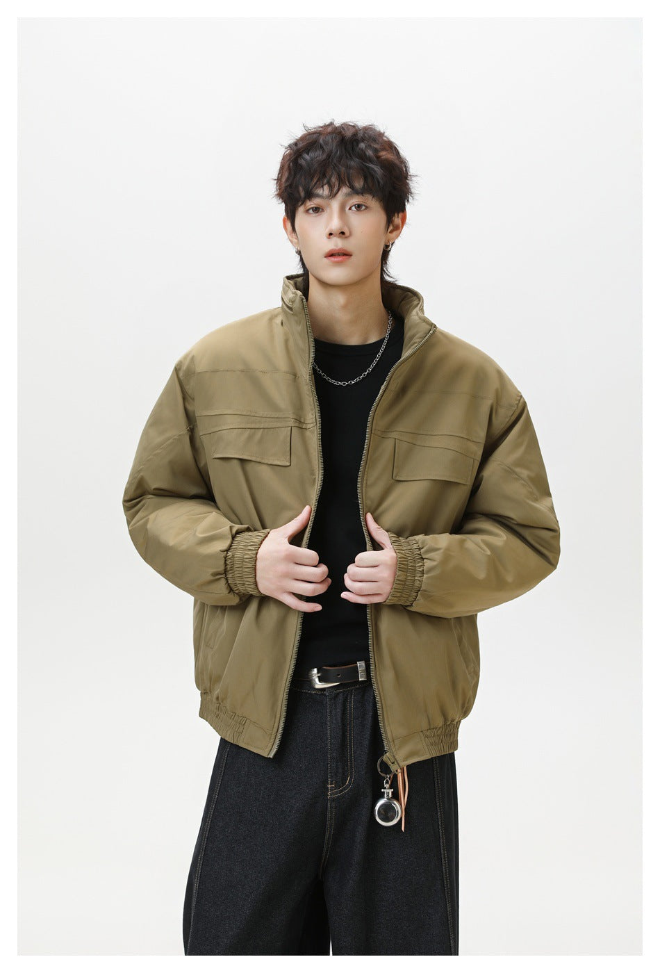 Model wearing an open olive-brown jacket with a stand collar, front zipper and two flap chest pockets.