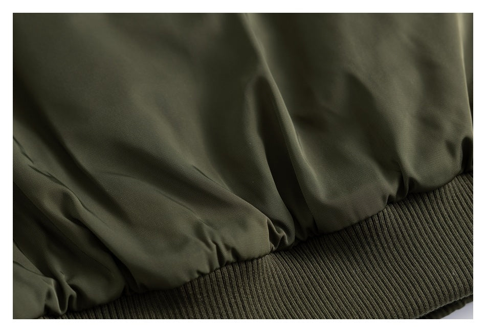 Close-up of gathered olive fabric above a wide ribbed knit hem.