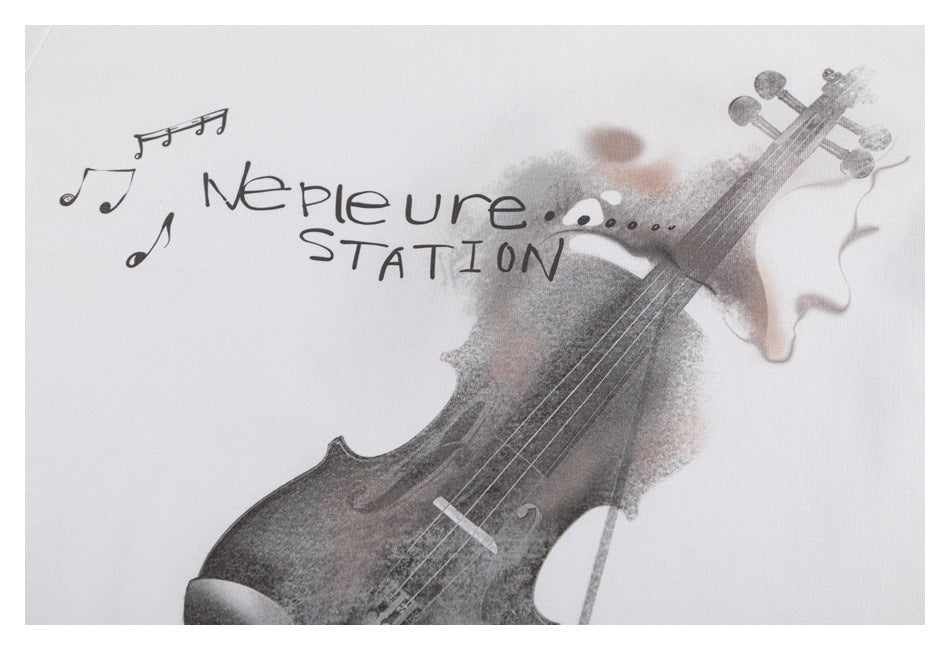 Close-up of the T-shirt's violin and musical-note print with stylized English lettering.